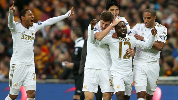 Nathan Dyer is congratulated by his Swansea team-mates after scoring against Bradford in the League Cup Final